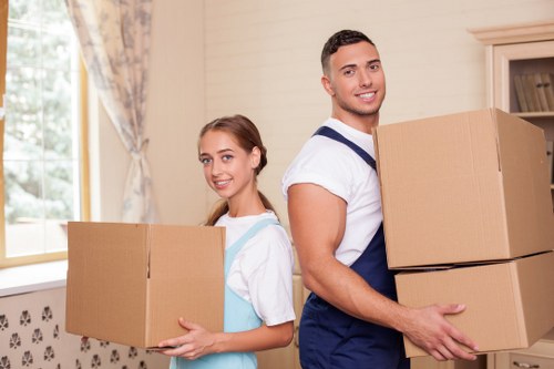 Professional movers handling furniture in a removal truck